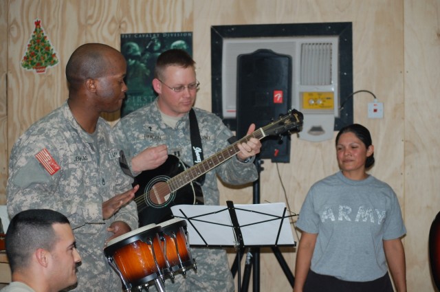 BAGHDAD - Soldiers from the 1st Squadron, 7th Cavalry Regiment, 1st Brigade Combat Team, 1st Cavalry Division, perform the hit Christmas song, "Feliz Navidad", as the final act in a Squadron talent show at Joint Security Station Istiqlaal, Dec....