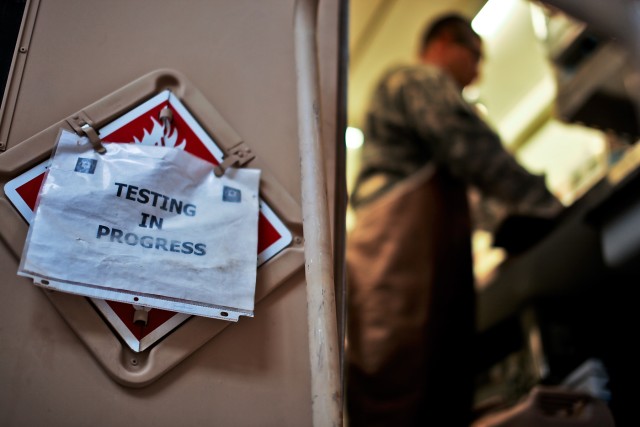 CAMP TAJI, Iraq - In a mobile petroleum testing lab, Spc. Juan Rodriguez-Cano, from Edinburg, Texas, a petroleum lab technician in Company A, 615th Aviation Support Battalion, 1st Air Cavalry Brigade, 1st Cavalry Division, sets up his equipment to...