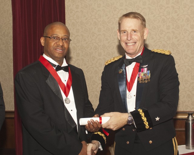 Etheridge accepts award