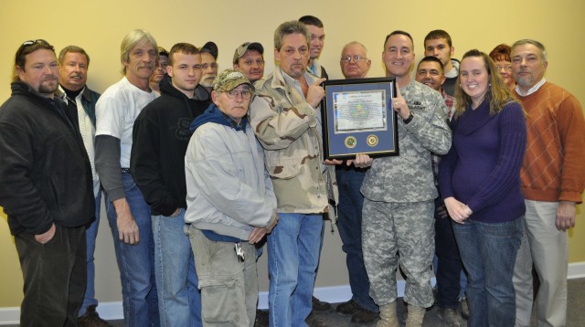 Depot Employees and the Commander Display Their Award