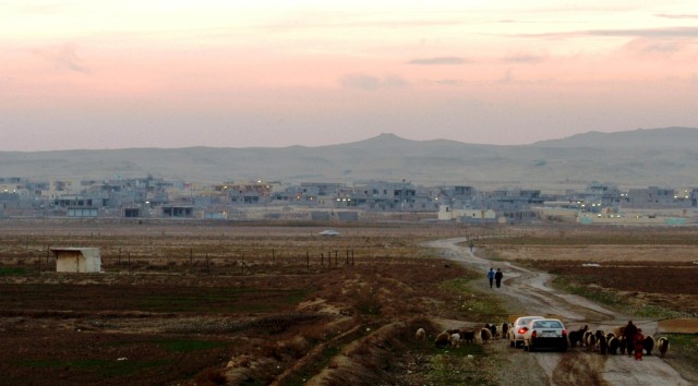 CONTINGENCY OPERATING LOCATION Q-WEST, Iraq - The city of Al Qayyarah at sunset, seen from a guard tower at the Al Qayyarah pump house during a maintenance mission Dec. 30. The pump house supplies potable water to Contingency Operating Location...