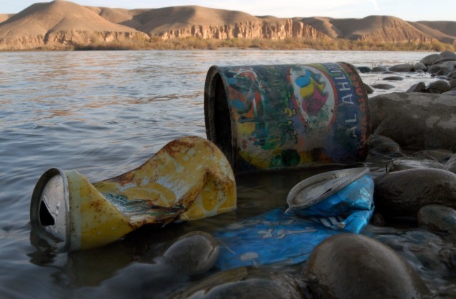 CONTINGENCY OPERATING LOCATION Q-WEST, Iraq - Discarded soda cans and a paint can lie along the western bank of the Tigris River near the Al-Qayyarah pump house Dec. 30. One of the things that impresses Ali Kaif Hussein, manager of the pump house,...
