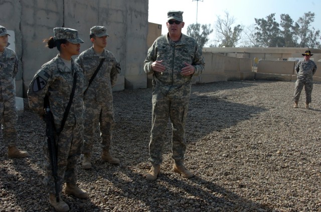 CAMP TAJI, Iraq -  Pfc. Harmony Rodriguez (from left), from Victoria, Texas, a cook in Company E, 4th Battalion, 227th Aviation Regiment, 1st Air Cavalry Brigade, 1st Cavalry Division, and her brother, Spc. Jeremiah Rodriguez, an aircraft electrician...