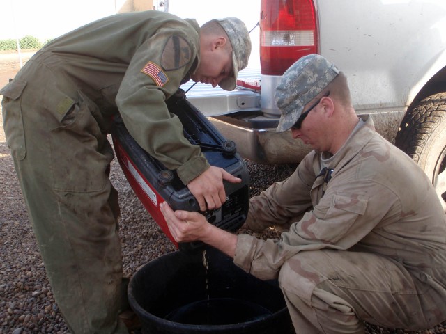 CAMP TAJI, Iraq - Beemer, Neb., native Spc. Devon Pagels (left) and Issaquah, Wash., native Spc. Brenton Nikolaus, both wheeled-vehicle mechanics assigned to Company B, 115th Brigade Support Battalion, 1st Brigade Combat Team, 1st Cavalry...