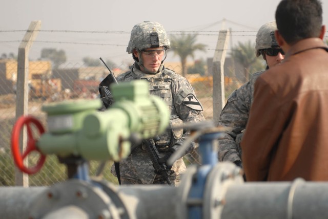JSS ISTIQLAAL, Iraq - Huntsville, Ala., native, 2nd Lt. John Wilson, a platoon leader assigned to 1st Squadron, 7th Cavalry Regiment, 1st Brigade Combat Team, 1st Cavalry Division, visits a water purifying system outside the gates of Joint...