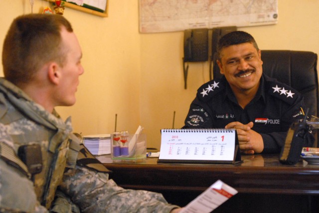 JSS ISTIQLAAL, Iraq - Huntsville, Ala. native, 2nd Lt. John Wilson (left), a platoon leader assigned to 1st Squadron, 7th Cavalry Regiment, 1st Brigade Combat Team, 1st Cavalry Division, visits the commander of a local federal police unit to gather s...