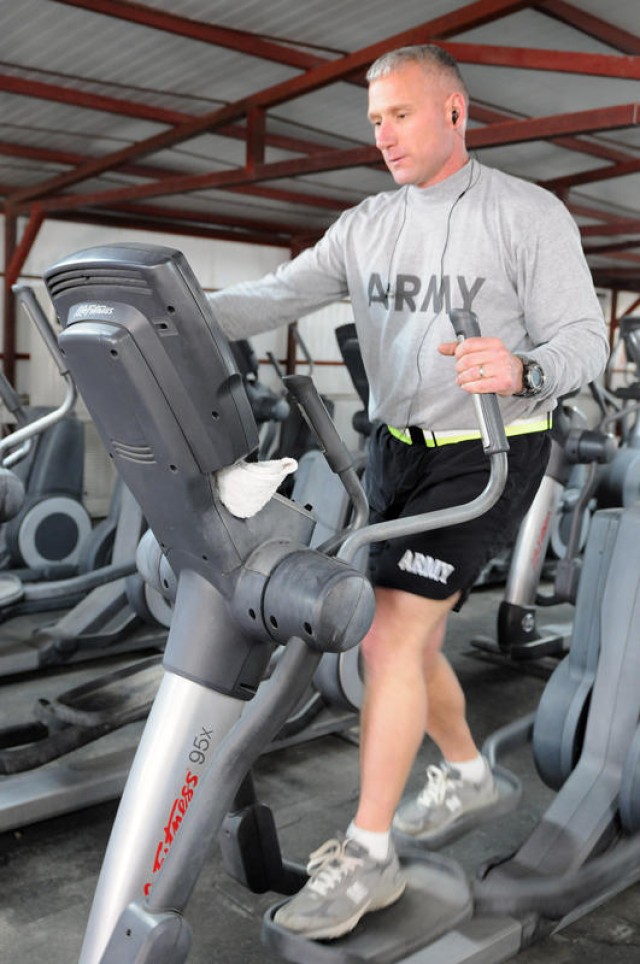 BAGHDAD - Command Sgt. Maj. William Johnson, the 1st Armored Division's senior non-commissioned officer, uses the elliptical machine at the division's gym, Jan. 10. Johnson, who works out every day, says it is important for leaders to stay physically...