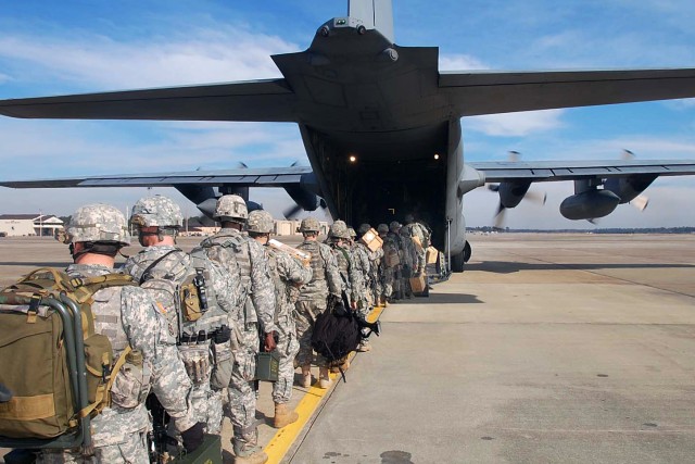 Soldiers board C-130