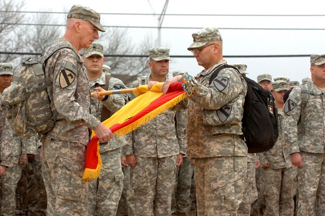Maj. Gen. Daniel Bolger (left), the 1st Cavalry Division commanding general, and Command Sgt. Maj. Rory Malloy, the division sergeant major, uncase the division's colors, signifying their return from combat operations during their homecoming ceremony...
