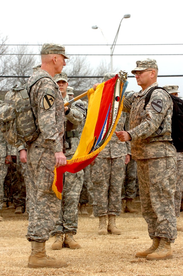 Maj. Gen. Daniel Bolger (left), the 1st Cavalry Division commanding general, and Command Sgt. Maj. Rory Malloy, the division sergeant major, uncase the division's colors, signifying their return from combat operations during their homecoming ceremony...