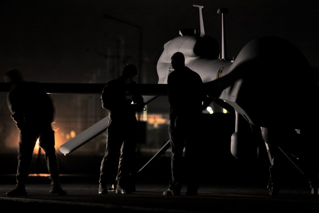 CAMP TAJI, Iraq - Two Soldiers (left and center) from Quick Reaction Capability 1, attached to 1st Air Cavalry Brigade, 1st Cavalry Division, U.S. Division - Center, and a civilian contractor from General Atomics Aeronautical Systems run the MQ-1C Sk...