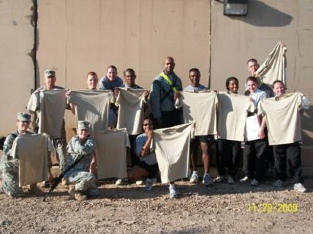 1LT Jones, CW3Talbot, SPC Hobbs, SSG Satterfied, SGT Edison, SSG Keaton, SFC Calvert, SSG Jones, SPC Lawwill, SSG Harris, SPC Threet, 1LT Weber, and SFC Randle pose with their Under Armor shirts outside R-Pod/H-7 Housing JBB, from Operation Troop...