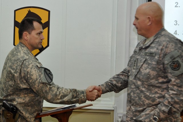 CONTINGENCY OPERATING LOCATION Q-WEST, Iraq - Lt. Gen. Kenneth Hunzeker, the United States Forces - Iraq deputy commanding general, shakes hands with Lt. Col. Allen Cassell, the support operations officer for the 15th Sustainment Brigade, during a lo...