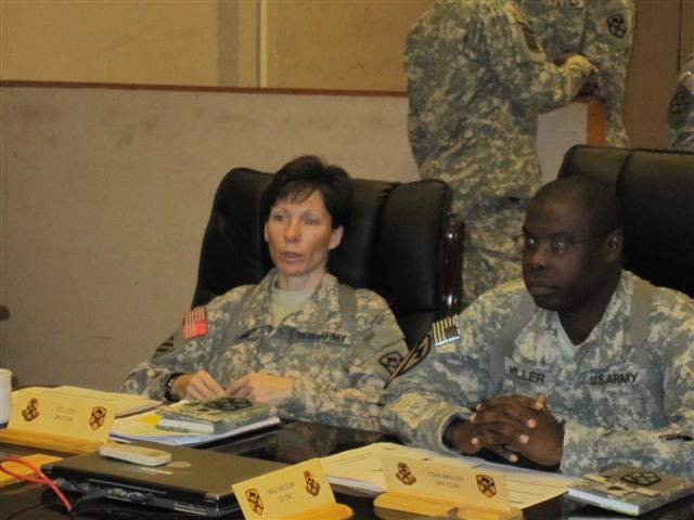 Lt. Col. Paula Lodi, the commander of the Special Troops Battalion, 15th Sustainment Brigade, 13th Sustainment Command (Expeditionary), and Command Sgt. Maj. Clarence Miller, the battalion's senior noncommissioned officer, receive a brief during the ...