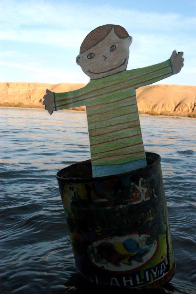 ONTINGENCY OPERATING LOCATION Q-WEST, Iraq - "Flat Stanley," a paper doll used in a pen-pal program, propped on the western shore of the Tigris River near the Al-Qyarrah pump station compound, the source of water supplying Contingency Operating Locat...
