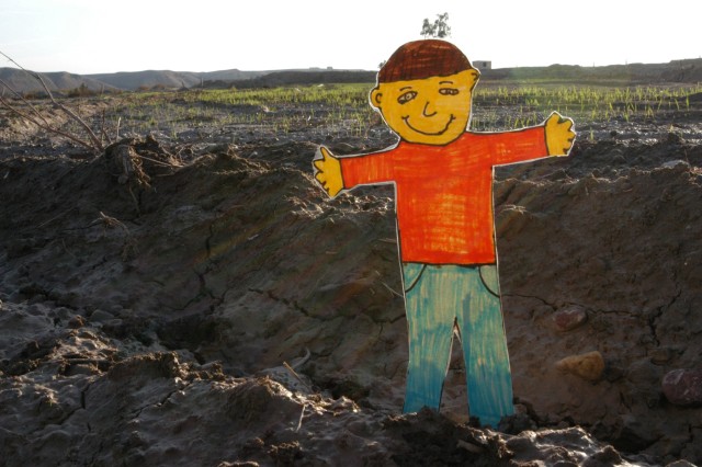 CONTINGENCY OPERATING LOCATION Q-WEST, Iraq - "Flat Stanley," a paper doll used in a pen-pal program, propped at the edge of an Iraqi winter wheat field near the Al-Qyarrah pump station compound, the Tigris River source of water supplying Contingency...
