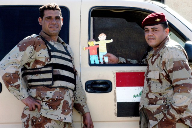 CONTINGENCY OPERATING LOCATION Q-WEST, Iraq - Iraqi Army Pvt. Meyd Abud (left) and Sgt. Alla Buel Hussein, members of 1st Company, 2nd Battalion, 26th Brigade, pose at the Al-Qyarrah pump station compound, the Tigris River source of water...