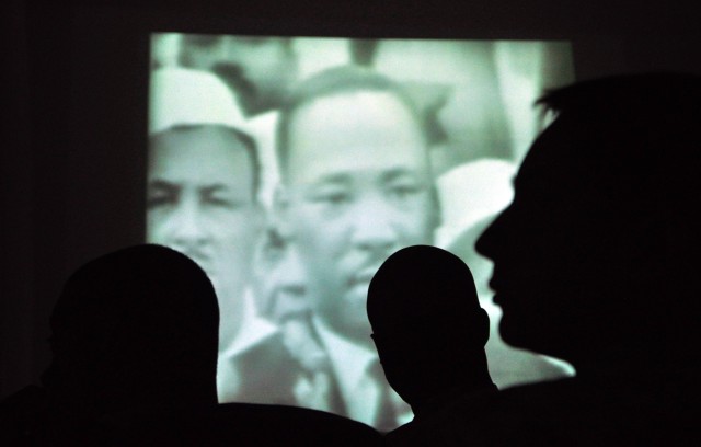 Soldiers watch a recording of Martin Luther King Jr.'s famous "I Have a Dream" speech at an observance at the Morale Welfare and Recreation tent here Jan. 18 hosted by the 15th Special Troops Battalion, 15th Sustainment Brigade, 13th Sustainment...