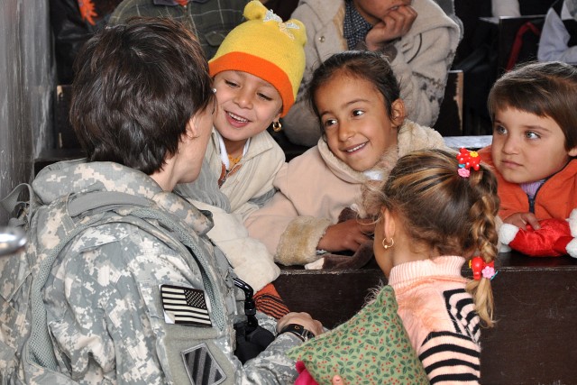 Lt. Col. Paula Lodi, the commander of the Special Troops Battalion, 15th Sustainment Brigade, talks to Iraqi students during a visit to their school Jan. 20 in the village of Jedellah Sofla, Iraq. (U.S. Army photo by Staff Sgt. Rob Strain, 15th...