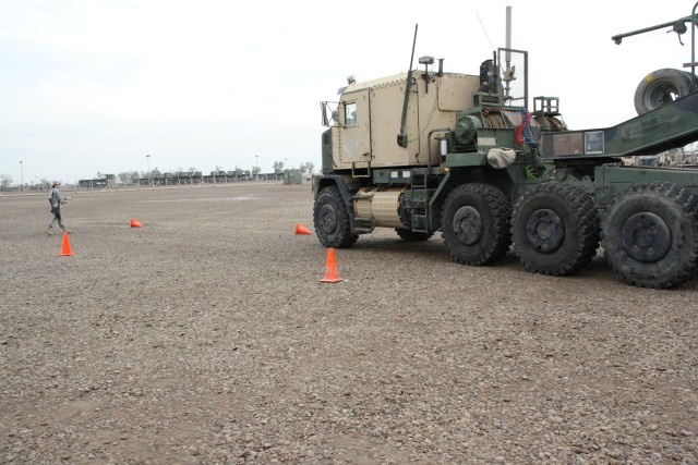 A Soldier from the 1483rd Transportation Company, 541st Combat Sustainment Support Battalion, 15th Sustainment Brigade, 13th Sustainment Command (Expeditionary), knocks over cones while attempting to do straight-line backing with a heavy equipment...