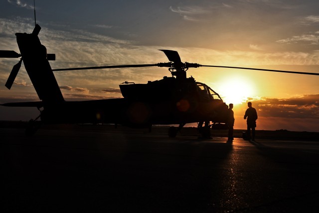 AL ASAD, Iraq - Before the start of an evening flight, Chief Warrant Officer 5 Mike Reese (left), an AH-64D Apache attack helicopter pilot and the senior standardization pilot for 1st Air Cavalry Brigade, U.S. Division - Center, conducts a mission br...