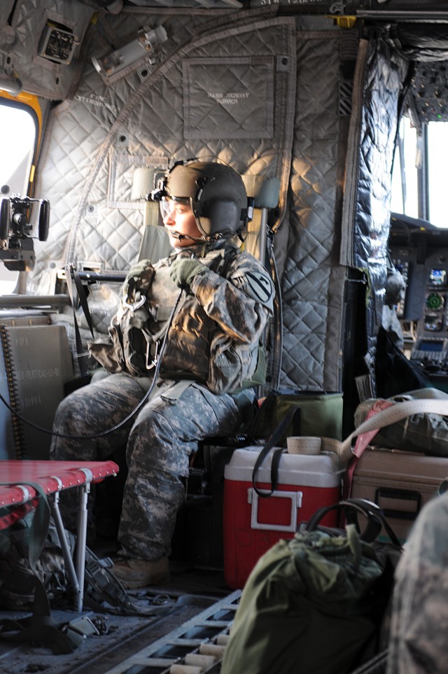 BAGHDAD - Spc. Bernice Garcia, a Houston native and Chinook door-gunner with Company B, 3rd Battalion, 227th Aviation Regiment, 1st Aviation Cavalry Brigade, 1st Cavalry Division, tests her radio Jan. 21, before taking her position in the window...
