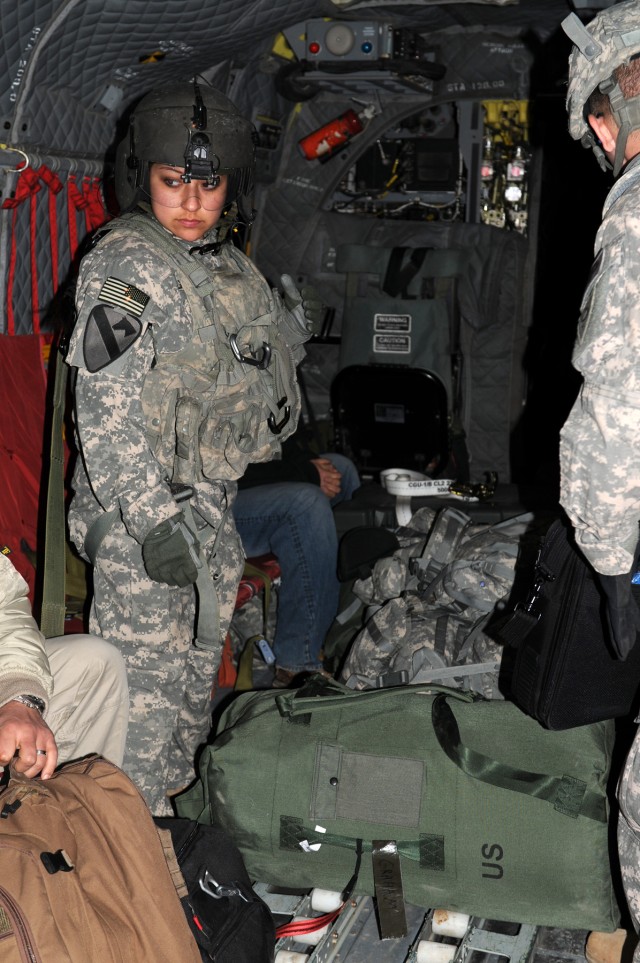 BAGHDAD - Spc. Bernice Garcia, a Houston native and Chinook door gunner with Company B, 3rd Battalion, 227th Aviation Regiment, 1st Aviation Cavalry Brigade, 1st Cavalry Division, who lives by the motto: when in charge, take charge, directs passenger...