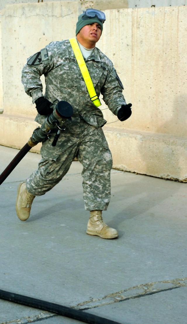 CAMP TAJI, Iraq- Pvt. Maurilio Renteria, from Boca Raton, Fla., an aircraft fuel handler in Company E, 2nd Battalion, 227th Aviation Regiment, 1st Air Cavalry Brigade, 1st Cavalry Division, U.S. Division - Center, rounds up the fuel hose after...