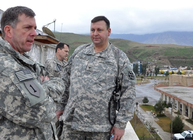 Brig. Gen. Paul Wentz [left], commander of the 13th Sustainment Command (Expeditionary) out of Fort Hood, Texas, talks with Col. Larry Phelps, 15th Sustainment Brigade, 13th ESC, commander and Greenville, Ala., native on a balcony here, Jan. 21....