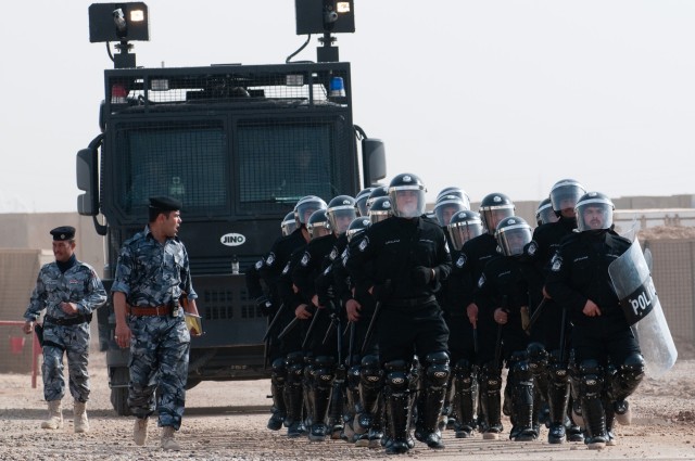 Graduating police with anti-riot vehicle
