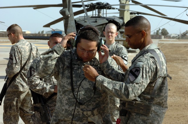 CAMP TAJI, Iraq - While adjusting the mouthpiece, Lt. Col. Charles Dalcourt (right), of Baton Rouge, La., commander, 1st Battalion, 227th Aviation Regiment, 1st Air Cavalry Brigade, 1st Cavalry Division, U.S. Division-Center, shows Cpl. Charles...