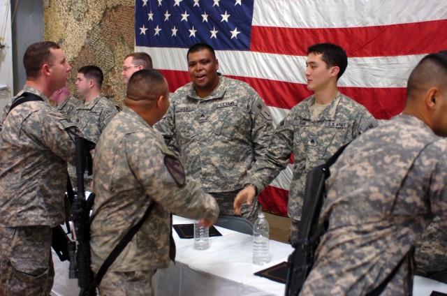 CAMP TAJI, Iraq - Soldiers from 1st Air Cavalry Brigade, 1st Cavalry Division, U.S. Division-Center, shake hands with wounded warriors who were visiting as part of Operation Proper Exit, a program designed to bring wounded veterans back to the...
