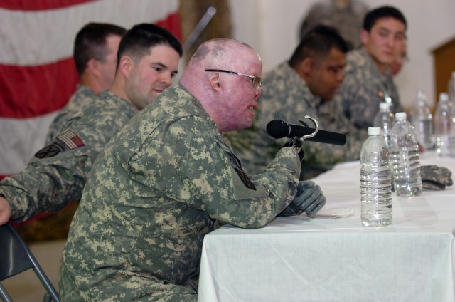 CAMP TAJI, Iraq - At a town hall forum, Sgt. 1st Class Michael Schlitz speaks to an audience of 1st Air Cavalry Brigade, 1st Cavalry Division, U.S. Division-Center, service members here Feb. 4 as part of Operation Proper Exit, a program which...