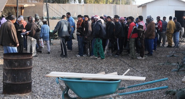 Iraqi workers with Noor Al-Belad Company wait to be placed into crews to perform base beautification Feb. 2 at Joint Base Balad, Iraq. Members of the 547th Transportation Company, 49th Transportation Battalion, 15th Sustainment Brigade, 13th...