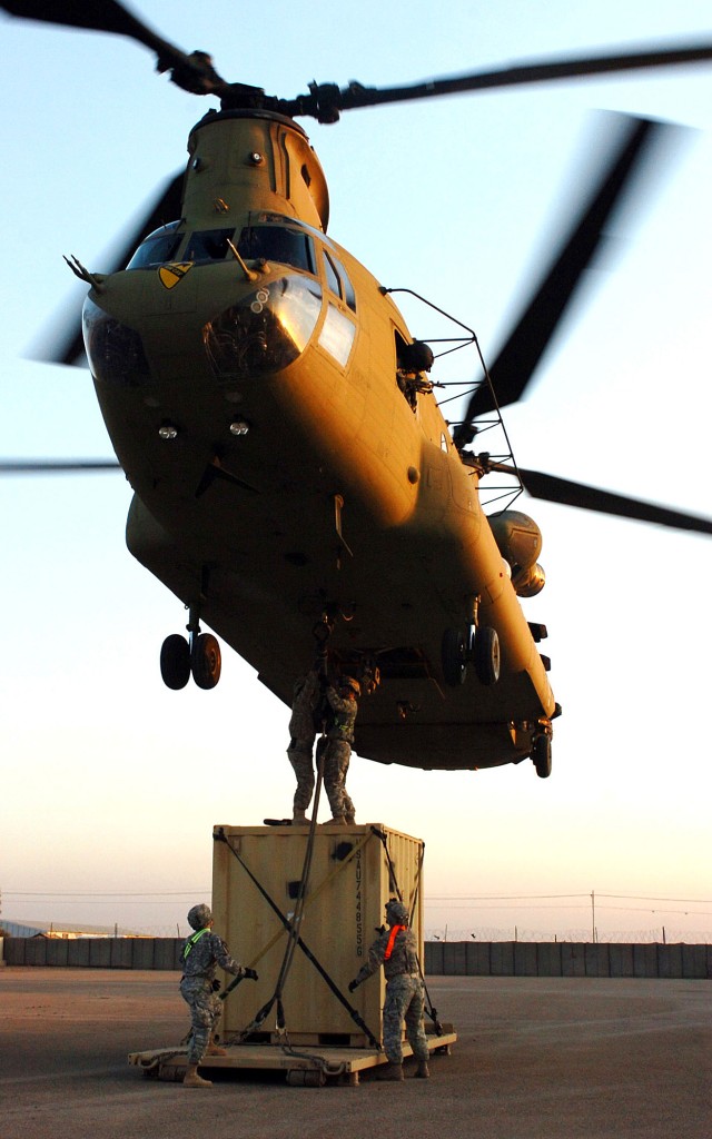 CAMP TAJI, Iraq-A combination of Soldiers from 1st Air Cavalry Brigade, 1st Cavalry Division, U.S. Division-Center, and 3rd Infantry Division attach a cable holding a container unit to a CH-47F Chinook helicopter, as part of a sling load. The Chinook...