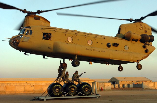 CAMP TAJI, Iraq-Soldiers from 1st Air Cavalry Brigade, 1st Cavalry Division, U.S. Division-Center, and the 3rd Infantry Division attach three fuel blivets to a CH-47F Chinook helicopter for a sling load mission Feb. 10. The blivets were being transpo...