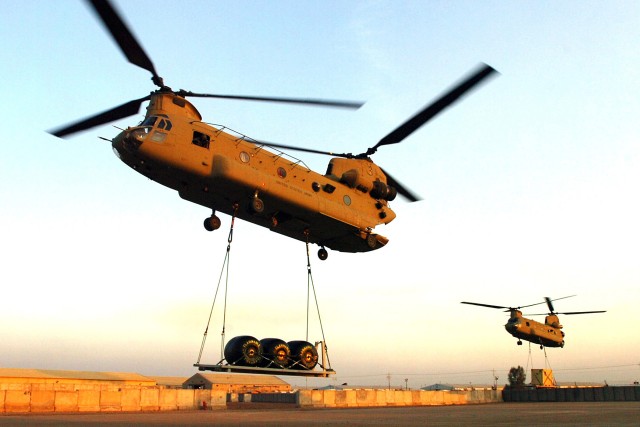 CAMP TAJI, Iraq-Two CH-47F Chinook helicopters from Company B, 2nd Battalion, 227th Aviation Regiment, 1st Air Cavalry Brigade, 1st Cavalry Division, U.S. Division-Center, depart Stryker heavy pad Feb 10 for a sling load mission here. The Chinooks ar...