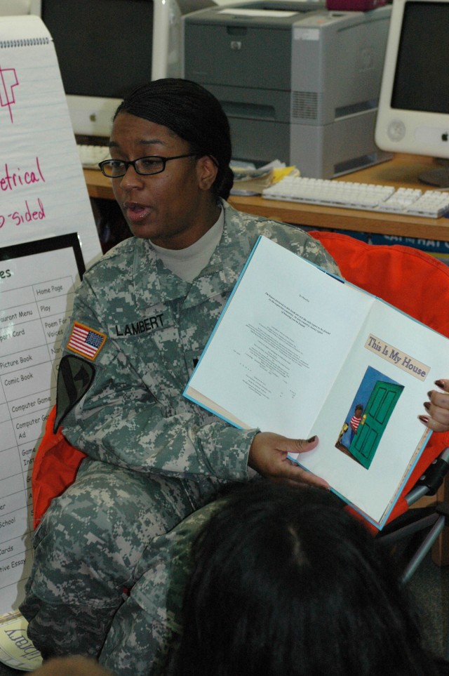 Capt. Deveilla Lambert, commander, 15th Special Troops Battalion rear detachment, 15th Sustainment Brigade, 13th Sustainment Command (Expeditionary) reads "This is my house" a children's book by Arthur Dorros to Alice Pomeroy's second grade class at ...