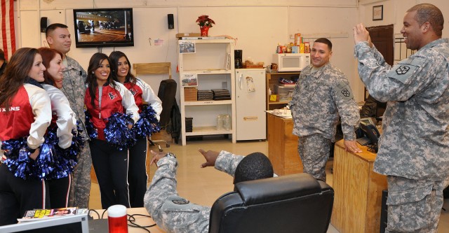 Professional football's Houston Texan cheerleaders visited Soldiers of the 15th Special Troops Battalion, 15th Sustainment Brigade, 13th Sustainment Command (Expeditionary) at work before doing a few cheers, posing for photos with service members...