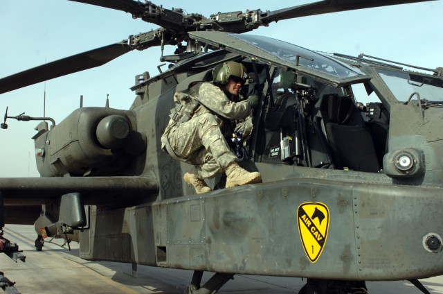 CAMP TAJI, Iraq - Spc. Zachary Andrade, from Coleman, Texas, an Apache crew chief in Company A, 1st Battalion, 227th Aviation Regiment, 1st Air Cavalry Brigade, 1st Cavalry Division, U.S. Division - Center, climbs in the front seat of an AH-64D Apach...