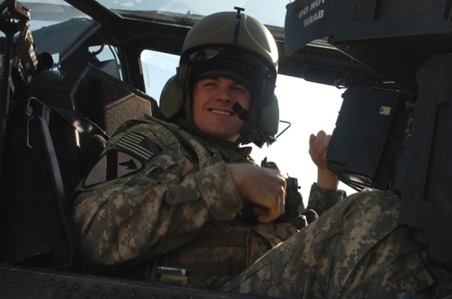 CAMP TAJI, Iraq - Spc. Beau Messer, from Royal Oak, Mich., a crew chief in Company B, 615th Aviation Support Battalion,1st Air Cavalry Brigade, 1st Cavalry Division, U.S. Division-Center, sits in the front seat of an AH-64D Apache attack...