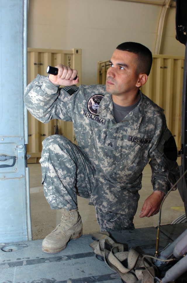 CAMP TAJI, Iraq-Shortly before beginning maintenance on a UH-60 Black Hawk helicopter, Sgt. Alexander Tarazona, from Bucumaranga, Colombia, a Black Hawk mechanic in Company D, 3rd Battalion, 227th Aviation Regiment, 1st Air Cavalry Brigade, 1st...