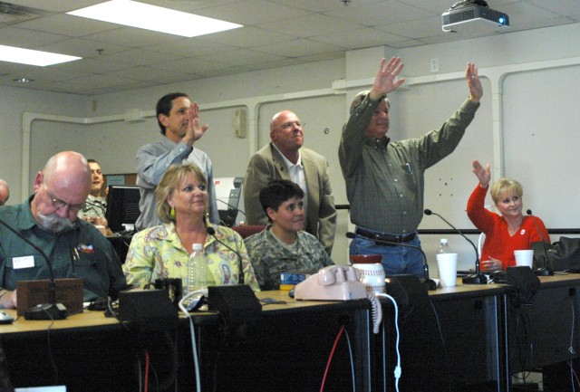 Lisa Phelps, wife of Col.  Larry Phelps, commander of the 15th Sust. Bde., 13th ESC and  members of the Belton community wave good bye to Col. Larry Phelps, commander of the 15th Sust. Bde., 13th ESC, and his command team during a video...
