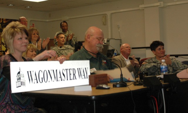 FORT HOOD, Texas- Stephanie O'Banion, president of the Belton area Chamber of Commerce holds a street sign as Jim Covington, the mayor of Belton, Texas reads a proclamation to Col. Larry Phelps, commander of the 15th Sust. Bde., 13th ESC, and his...
