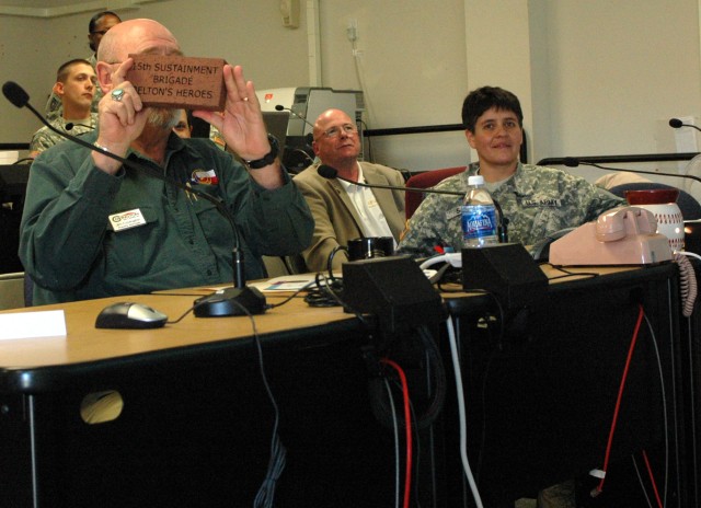 FORT HOOD, Texas- Jim Covington, Mayor of Belton, Texas shows an engraved brick to Col. Larry Phelps, commander of the 15th Sust. Bde., 13th ESC and his command team during a video teleconference at the brigade's headquarters building, here Jan....