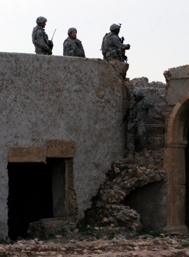 CONTINGENCY OPERATING LOCATION Q-WEST, Iraq - Mississippi Guardsmen with A Company, 2nd Battalion, 198th Combined Arms, 155th Brigade Combat Team, the Q-West force protection company from Hernando, Miss., descend the northwest rampart stairs of an...