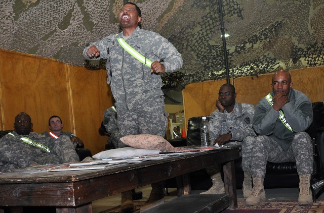 CONTINGENCY OPERATING LOCATION Q-WEST, Iraq - 1st Sgt. Willie Johnson, first sergeant for A Company, 15th Special Troops Battalion, 15th Sustainment Brigade, 13th Sustainment Command (Expeditionary), reacts to a play as he and other "Wagonmaster" Sol...