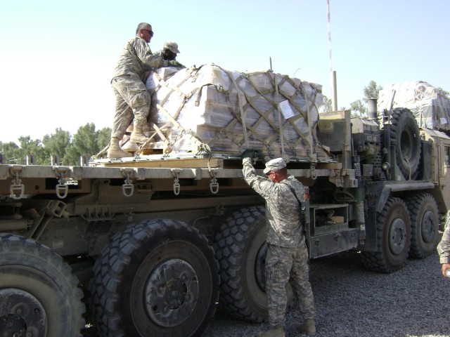 CAMP LIBERTY, Iraq - Soldiers from the 396th Transportation Company, 260th Combat Sustainment Support Battalion, 15th Sustainment Brigade, 13th Sustainment Command (Expeditionary) prepare a load on a palletized loading system for their move to...