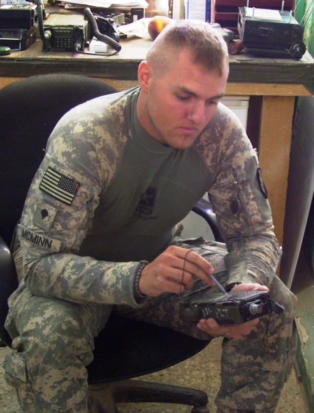 CONTINGENCY OPERATING LOCATION Q-WEST, Iraq - Spc. James B. McMinn, a Lake Village, Ark., native and a gunner serving with B Company, 2nd Battalion, 198th Combined Arms, 155th Brigade Combat Team, out of Greenwood, Miss., programs a hand-held...