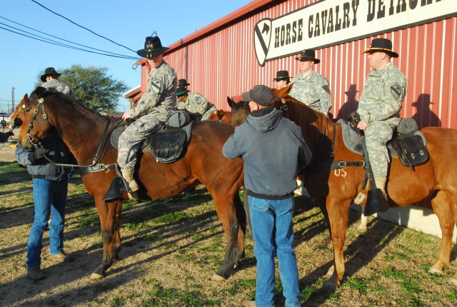 A group of Soldiers from 2nd Special Troops Battalion, 2nd Brigade Combat Team, 1st Cavalry Division, line up with horses from the Horse Cavalry Detachment, 1st Cav. Div. during a photo shoot on Fort Hood, Texas, Feb. 17. Although the STB is one...